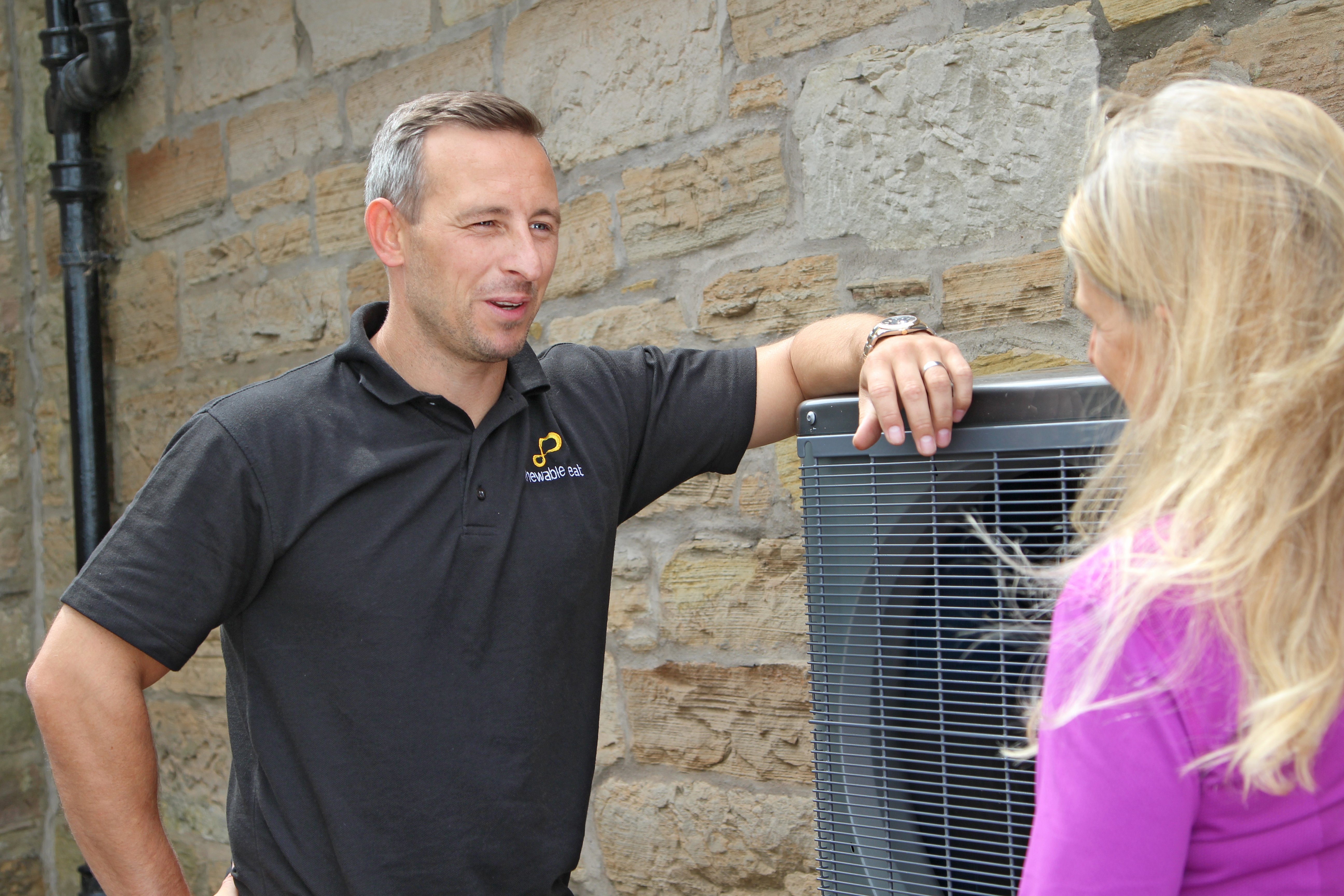 Renewable Heat engineer with a customer at an installed heat pump
